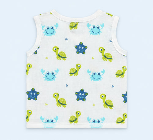 A sleeveless white baby tank top featuring a playful pattern of sea creatures, including green sea turtles, blue starfish, and light blue crabs, laid flat against a light blue background.