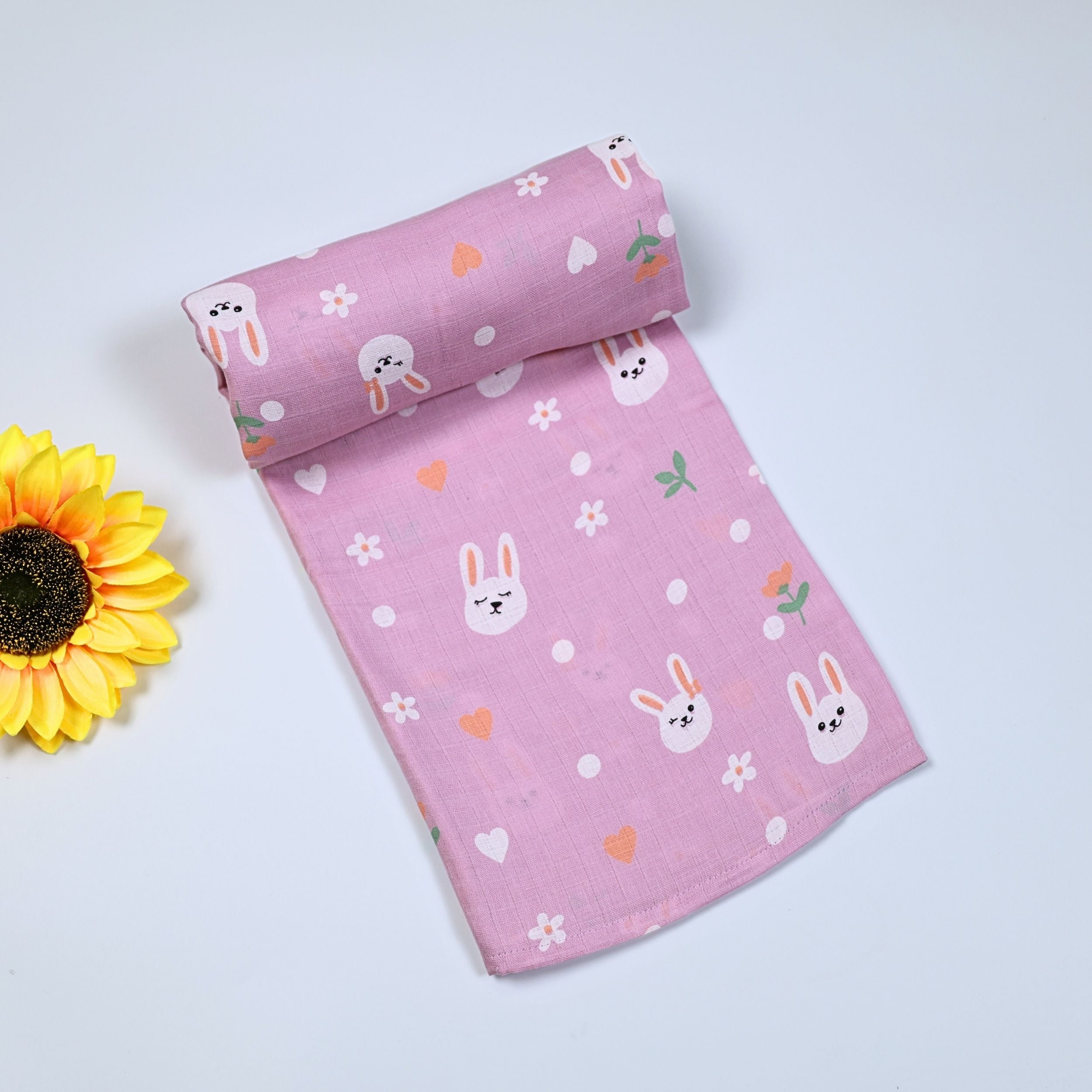 Bunny Hearts baby bath towel in pink, printed with bunny and flower pattern