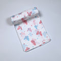 Butterfly Blush baby bath towel
 in white printed with pastel butterfly motifs in soft pink and blue tones.