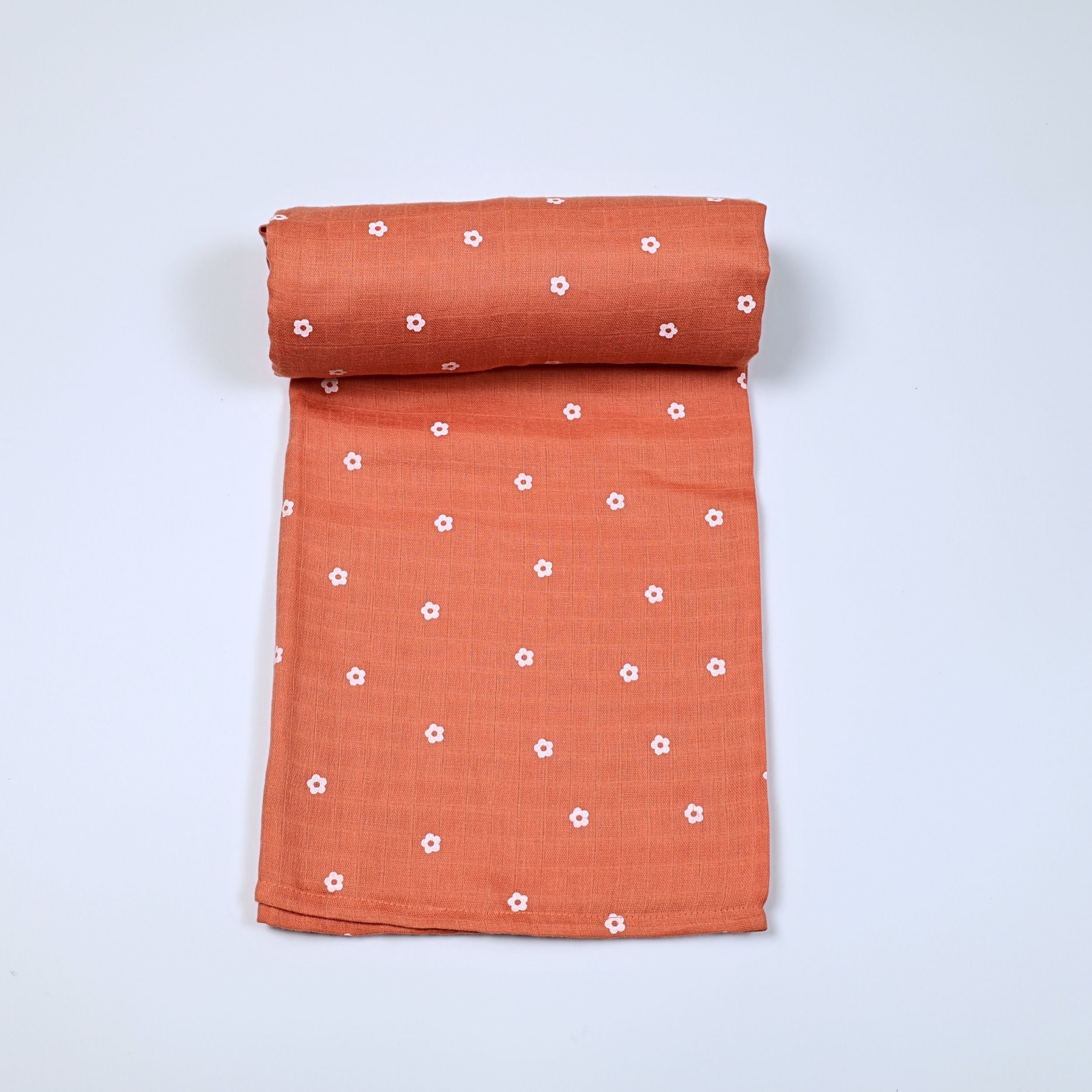 Daisy Daze baby bath towel in orange color, printed with white floral patterns