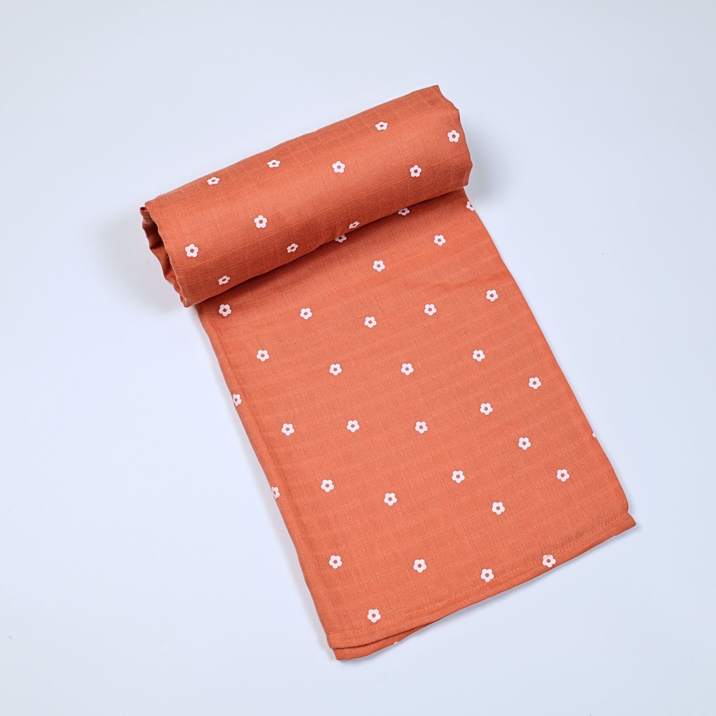 Daisy Daze baby bath towel in orange color, printed with white floral patterns