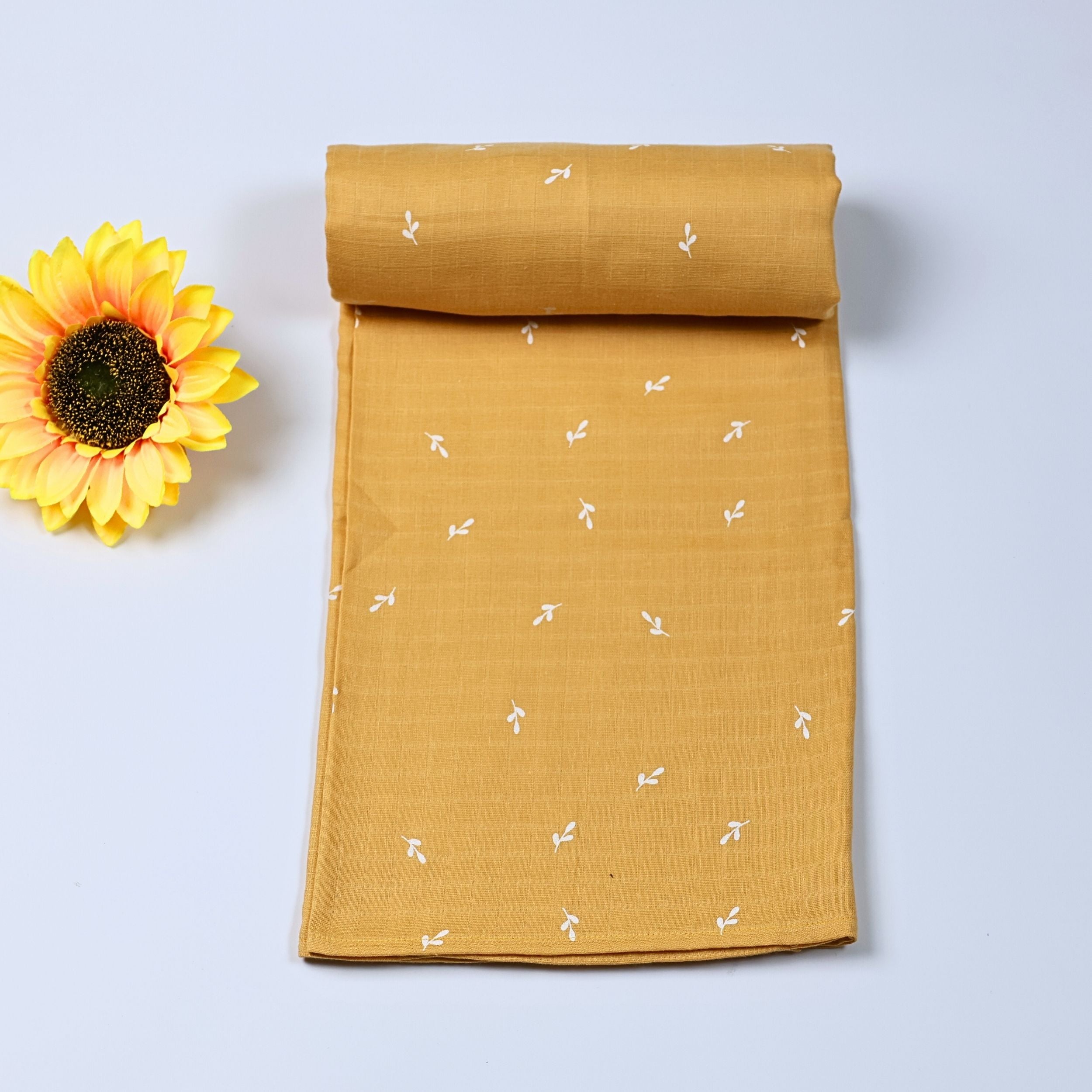 Mustard Sprigs baby bath towel in yellow, printed with white floral pattern