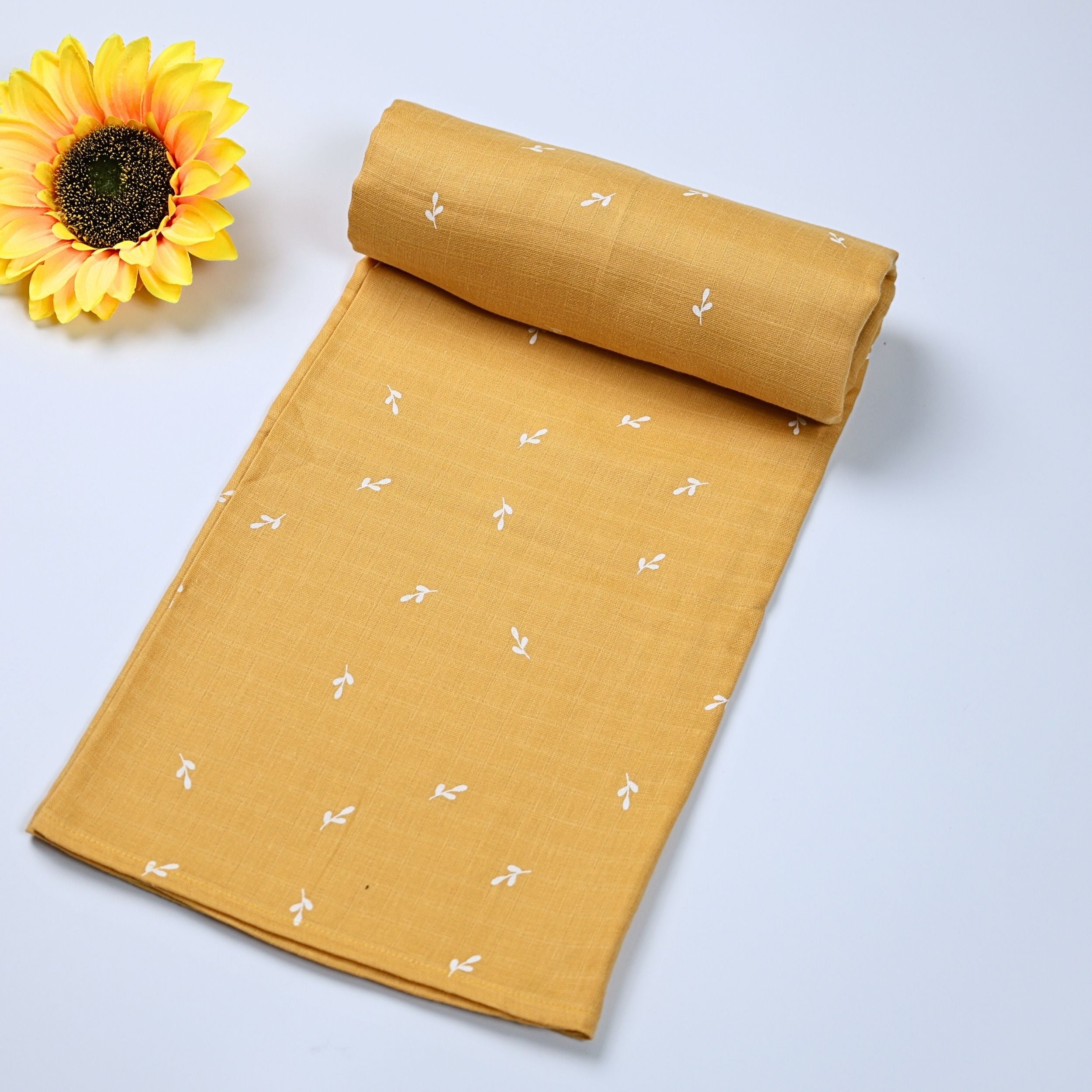Mustard Sprigs baby bath towel in yellow, printed with white floral pattern