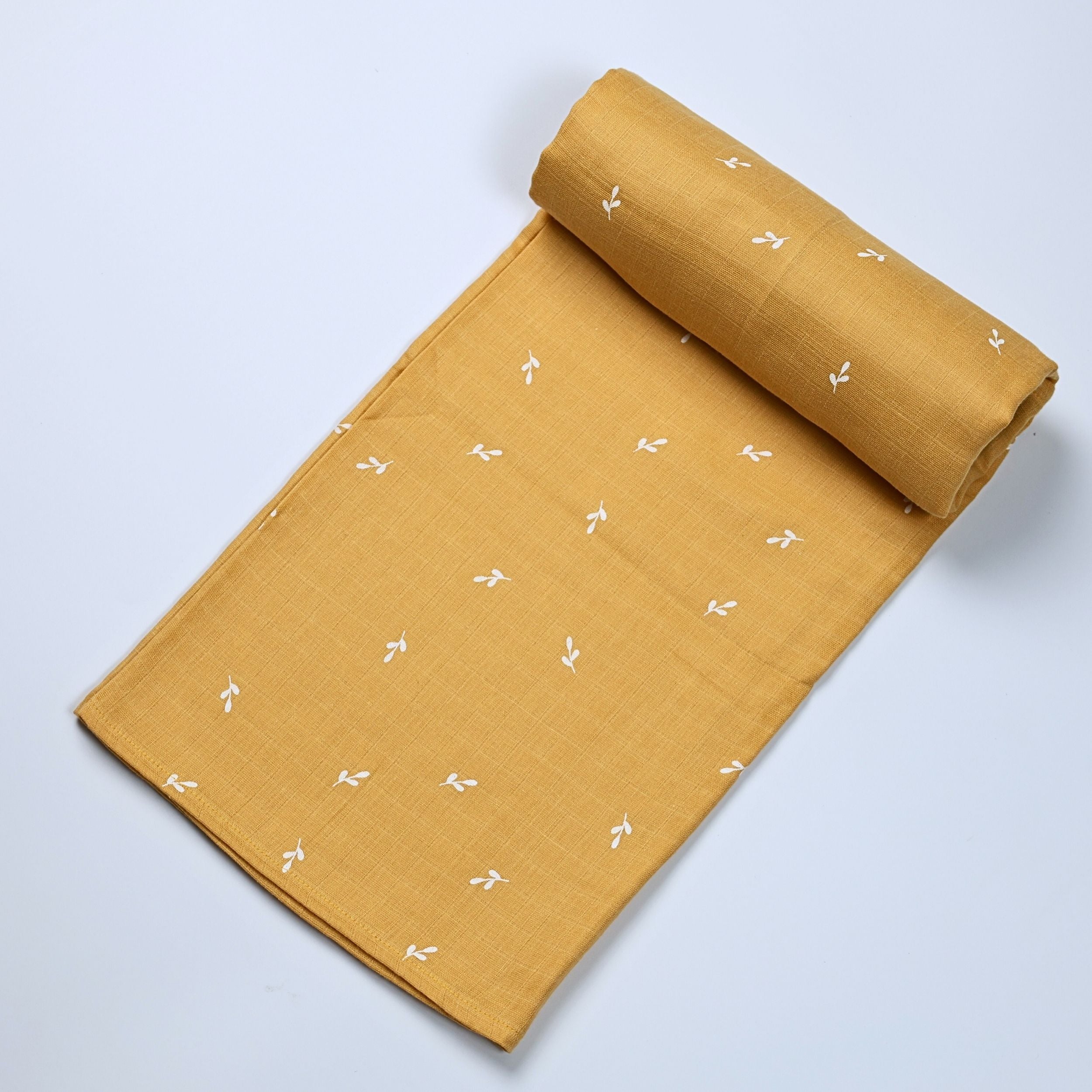 Mustard Sprigs baby bath towel in yellow, printed with white floral pattern