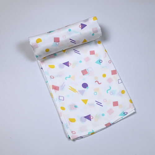 Shape Pops baby bath towel in white printed with colorful geometric pattern