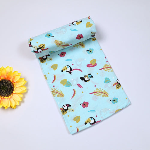 Tropical Toucans Baby bath towel in turquoise blue, printed with toucan and leaf pattern.