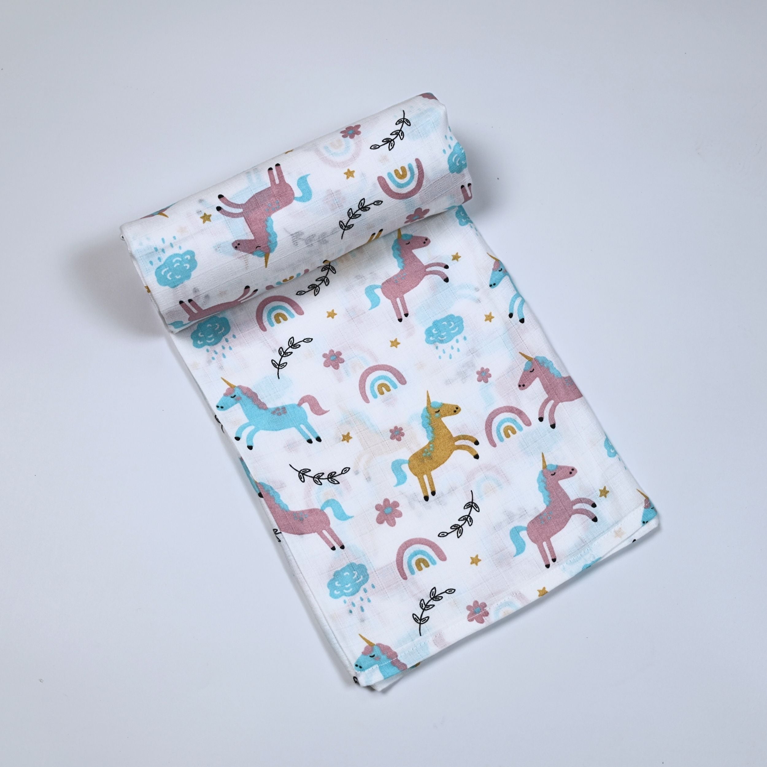 Unicorn baby bath towel in white, printed with unicorn and rainbow patterns