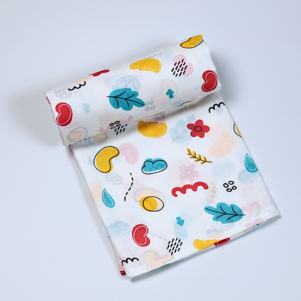Wild Doodles Baby bath towel in white printed with yellow, red and pastel green scribble patterns.