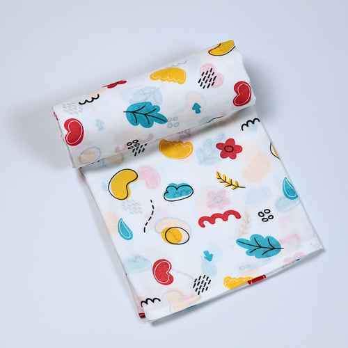 Wild Doodles Baby bath towel in white printed with yellow, red and pastel green scribble patterns.