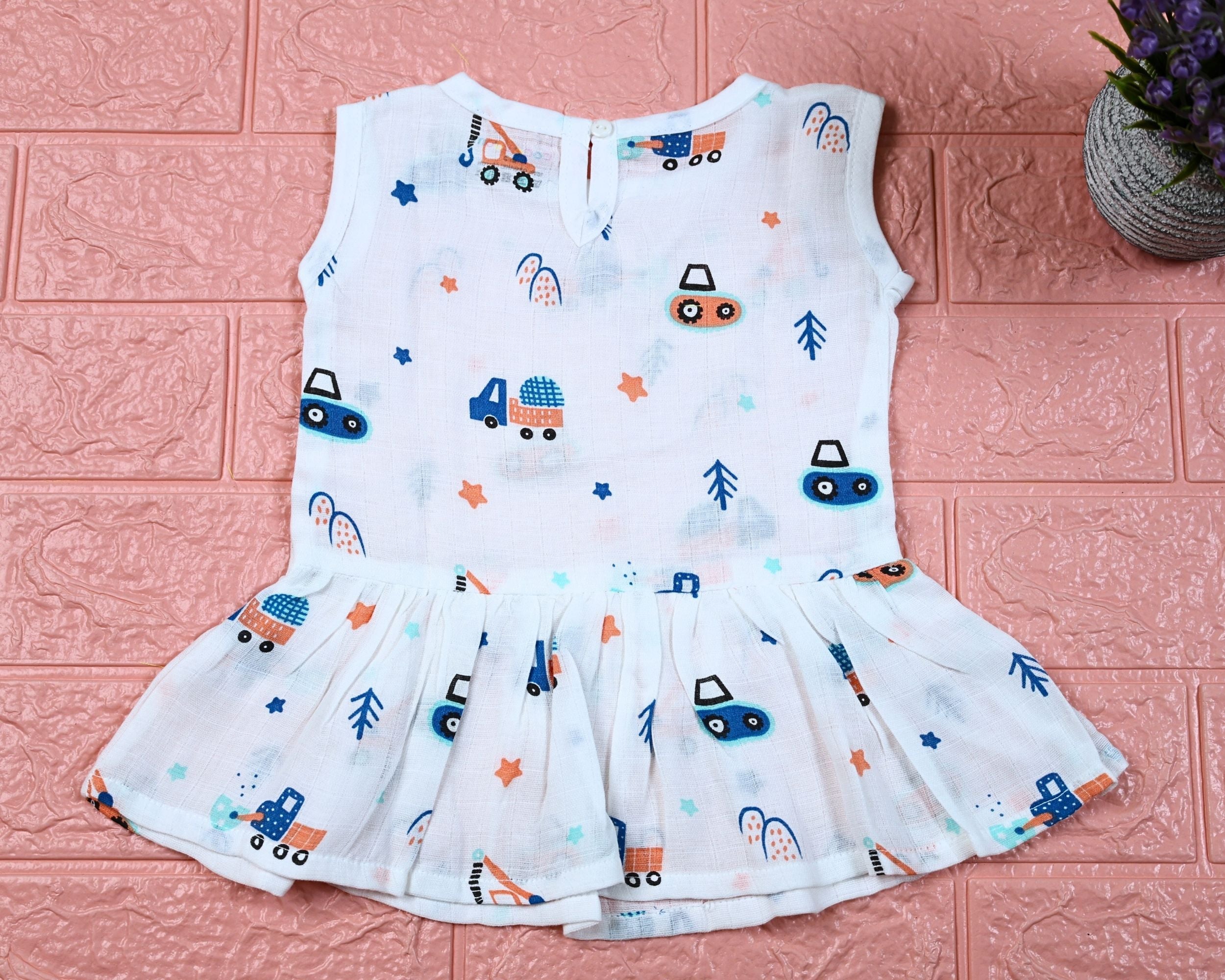 Crane Crew baby sleeveless frock in white with button, printed with construction equipment vehicle pattern