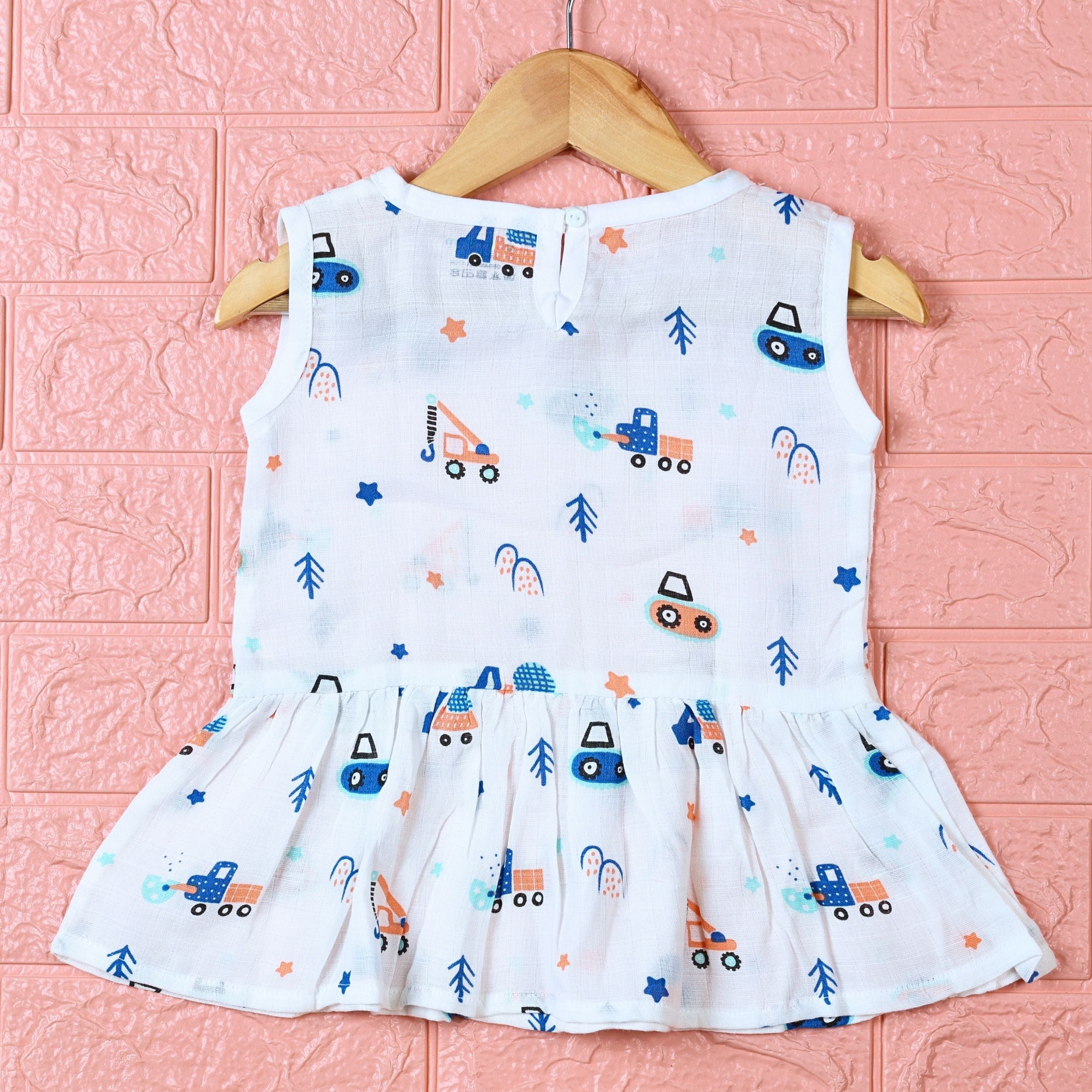 Crane Crew baby sleeveless frock in white with button, printed with construction equipment vehicle pattern