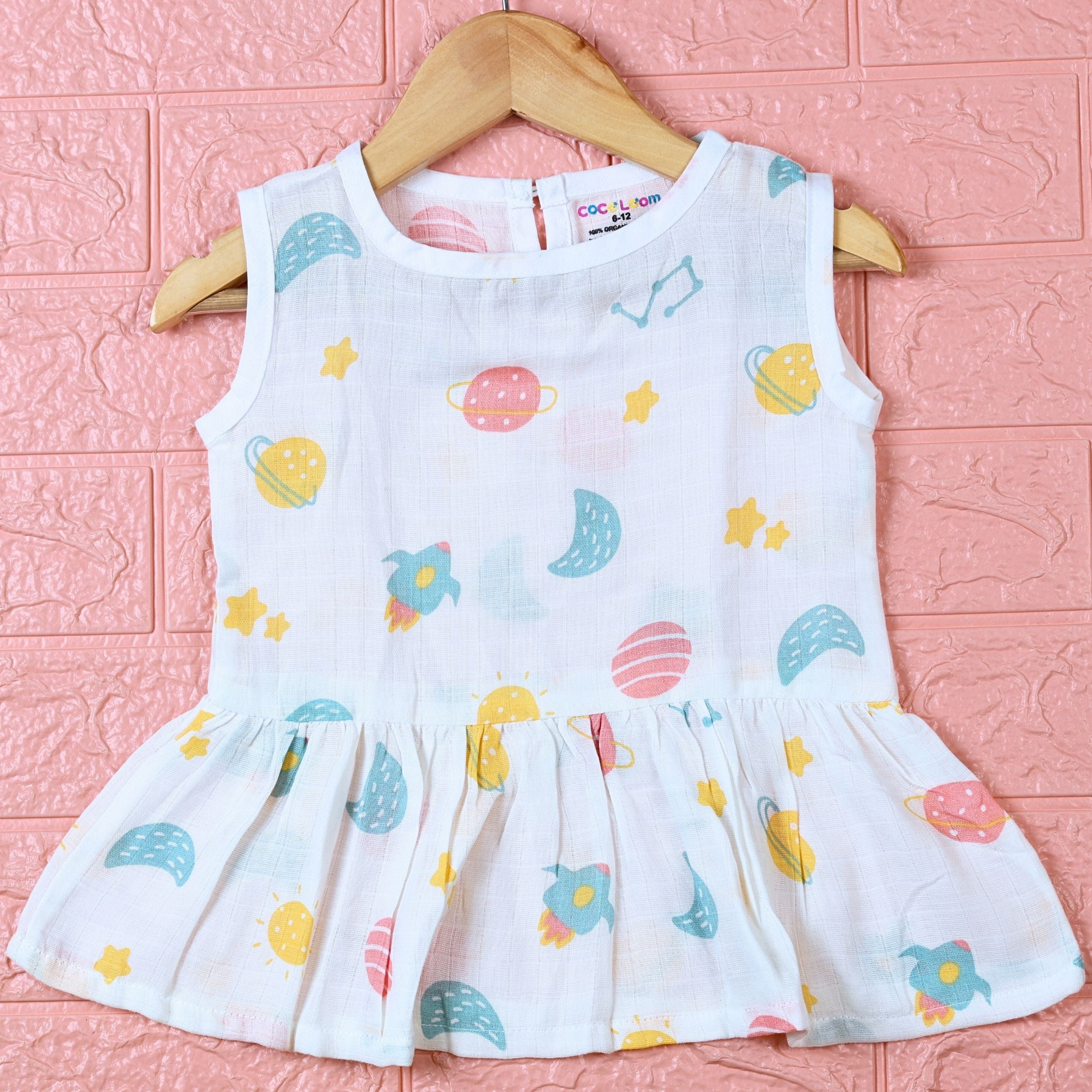 Galaxy Nights baby sleeveless frock in white with button, printed with galaxy themed pattern
