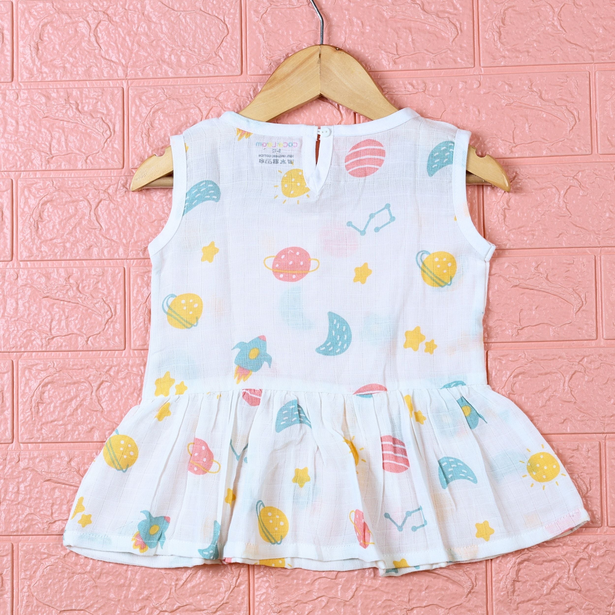 Galaxy Nights baby sleeveless frock in white with button, printed with galaxy themed pattern