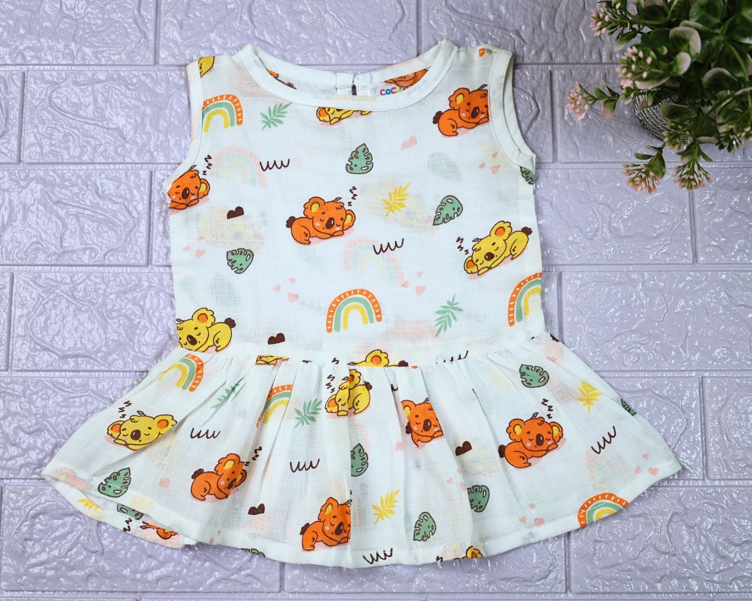 Koala Dreams baby sleeveless frock in white with button printed with bear and rainbow pattern