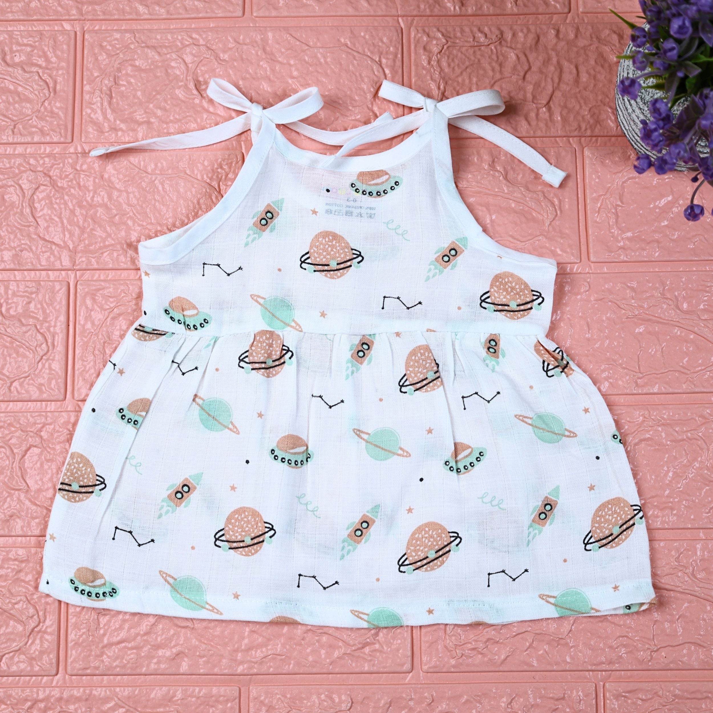 Cosmic Wonders Baby frock in white with tie up shoulders, printed with space-themed design