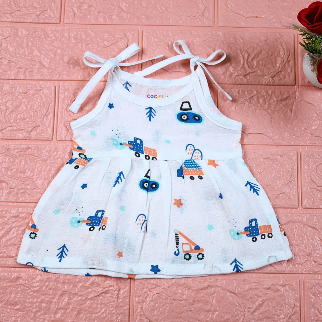 Crane Crew baby frock in white with tie up shoulders, printed with construction equipment vehicle pattern
