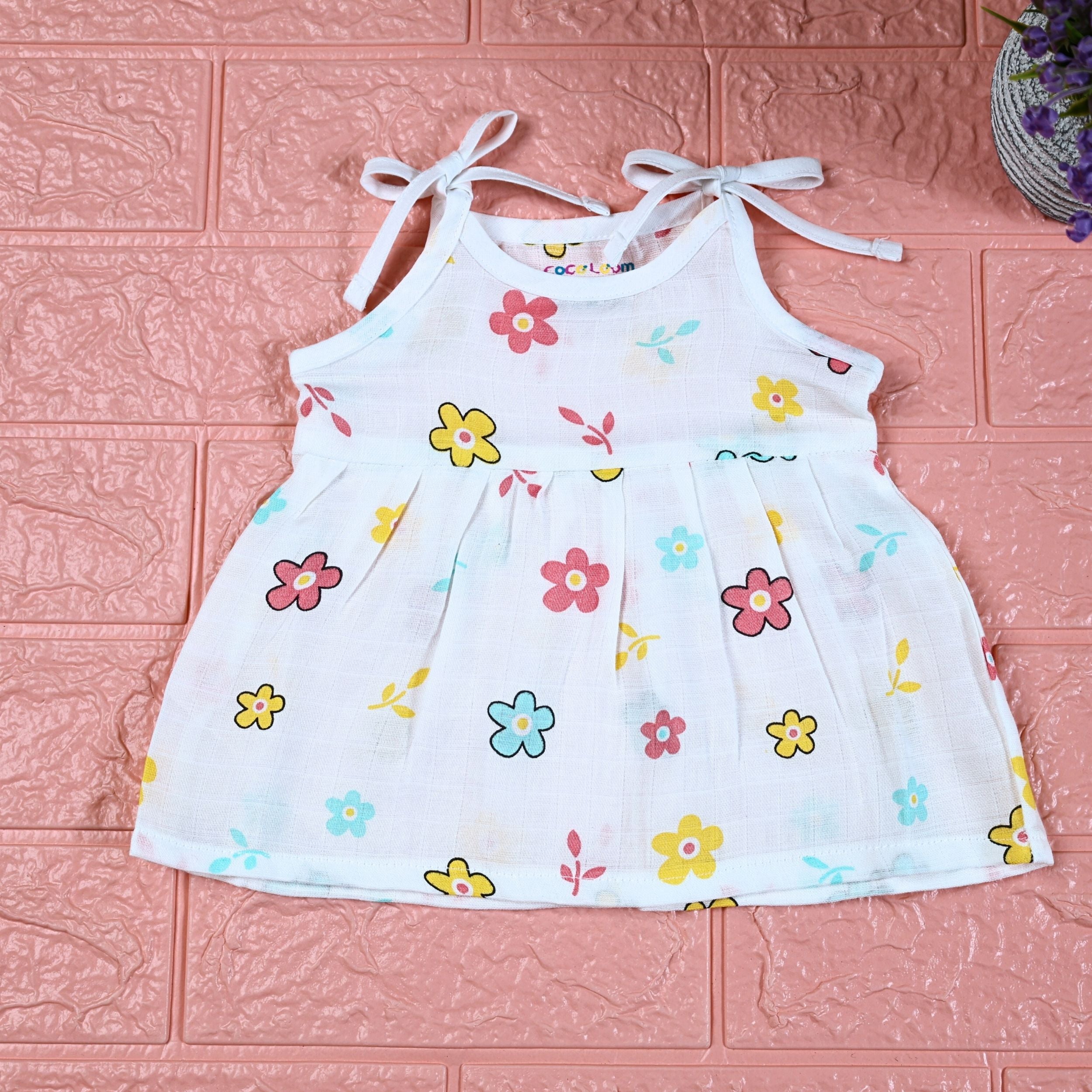 Flora Baby frock in white with tie up shoulders, printed with Floral pattern