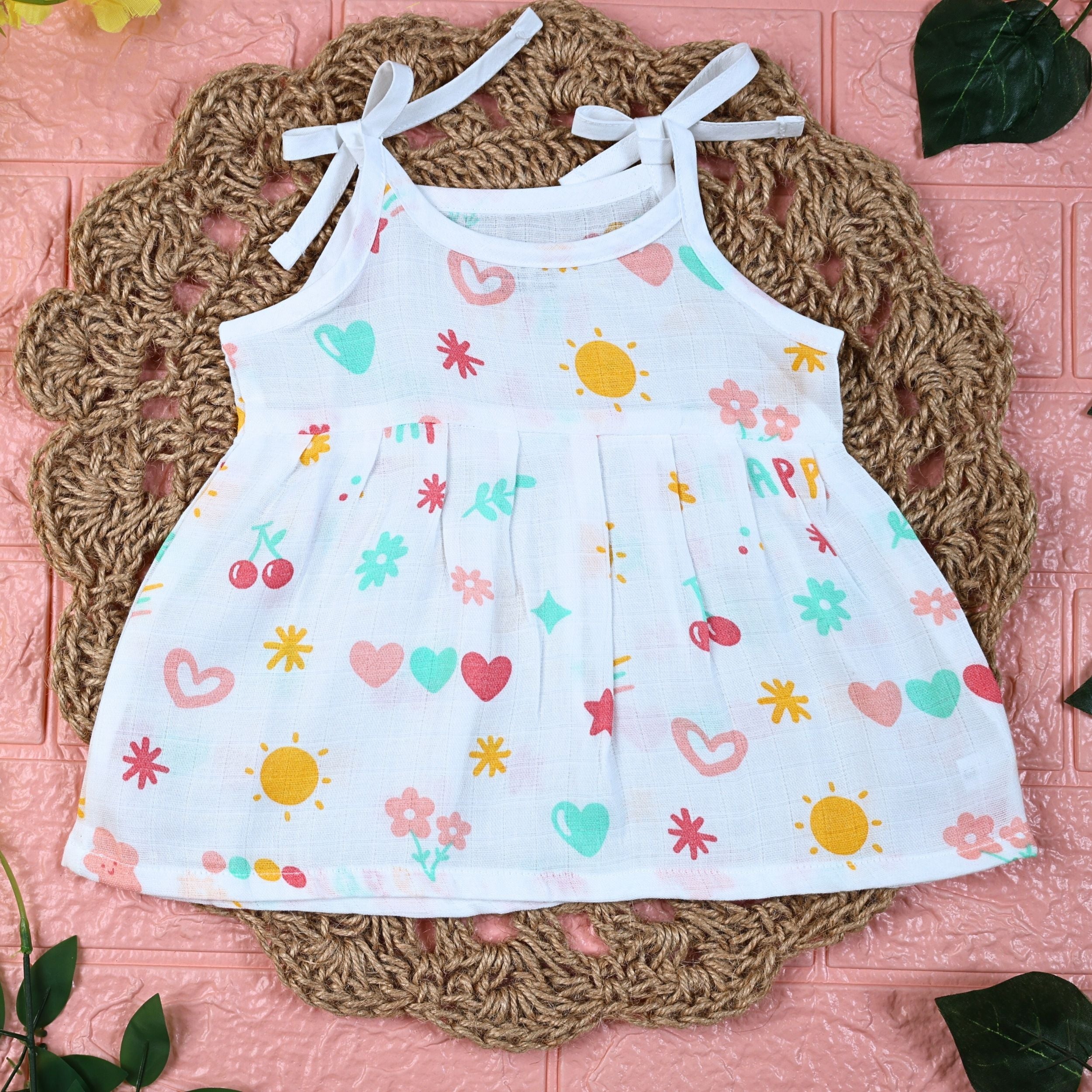 Happy Hearts baby frock in white with tie up shoulders, printed with colourful heart patterns