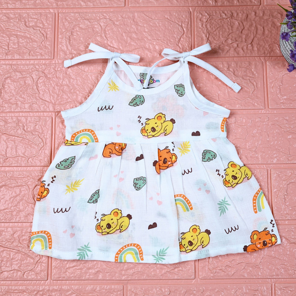 Koala Dreams baby frock in white with tie up shoulders, printed with bear and rainbow pattern
