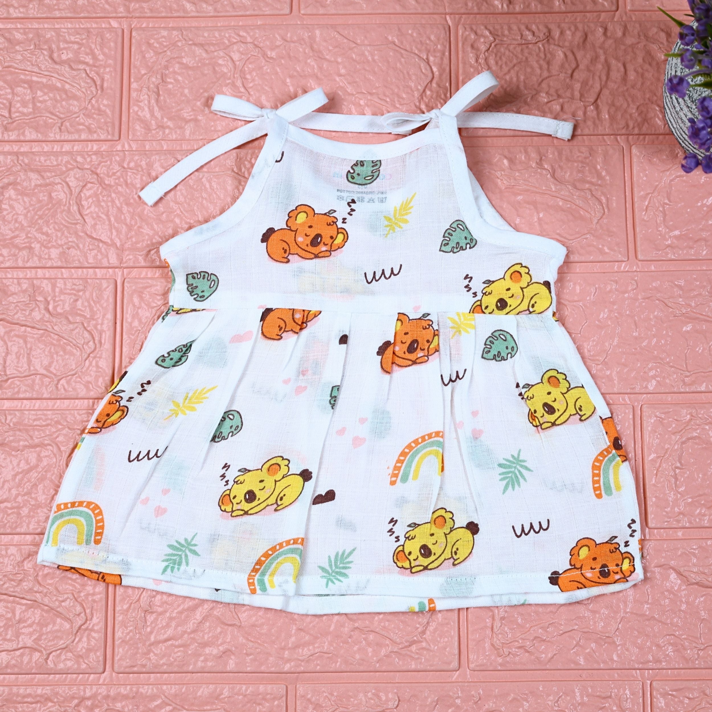 Koala Dreams baby frock in white with tie up shoulders, printed with bear and rainbow pattern