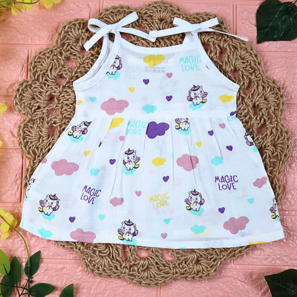 Purple Magic baby frock in white with tie up shoulders, printed with colourful patterns