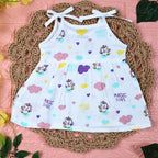 Purple Magic baby frock in white with tie up shoulders, printed with colourful patterns