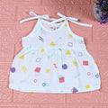 Shape Pops baby frock in white with tie up shoulders printed with colorful geometric pattern