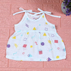 Shape Pops baby frock in white with tie up shoulders printed with colorful geometric pattern