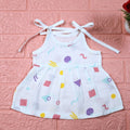 Shape Pops baby frock in white with tie up shoulders printed with colorful geometric pattern
