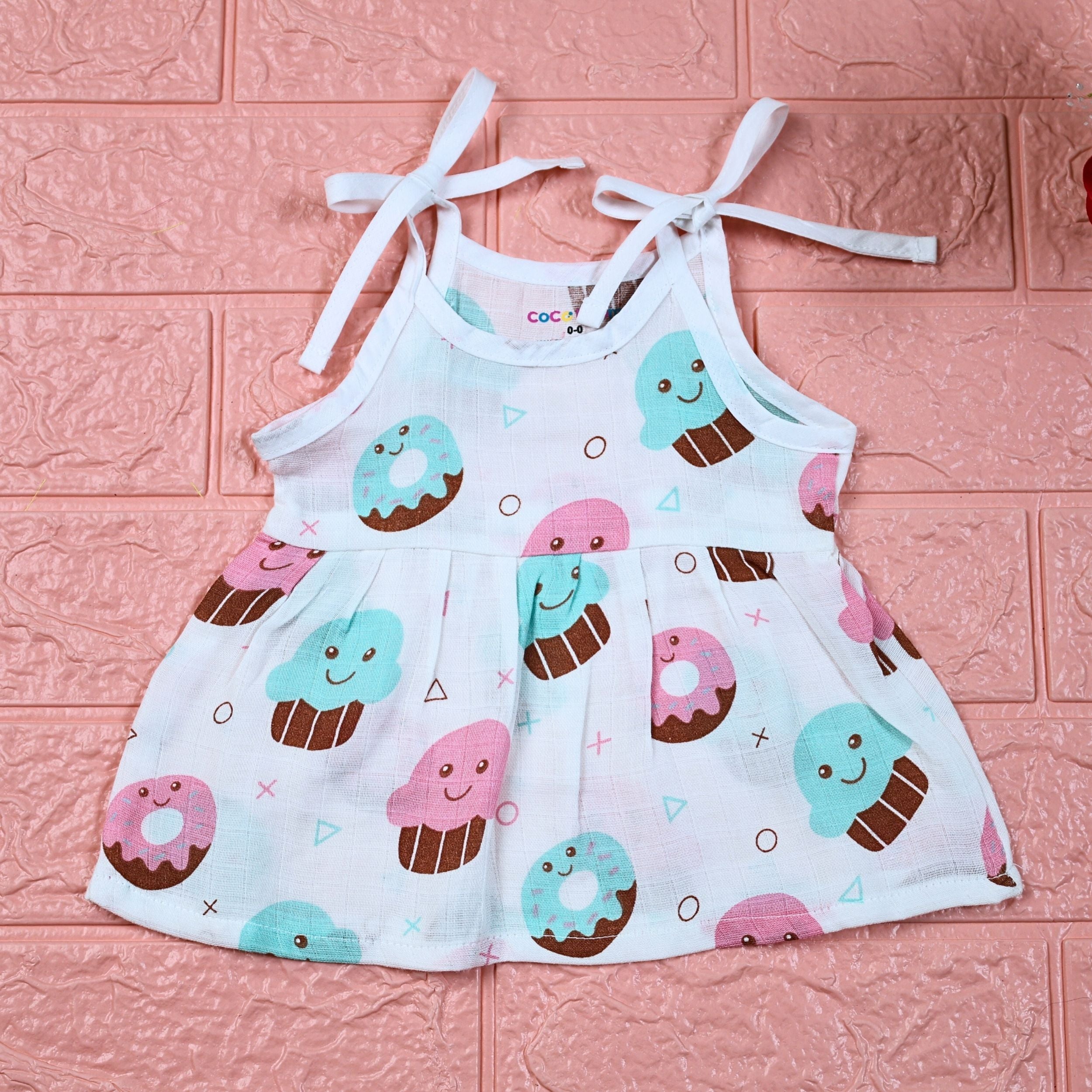Sugar Rush baby frock in white printed with tie up shoulders, printed with cup cakes