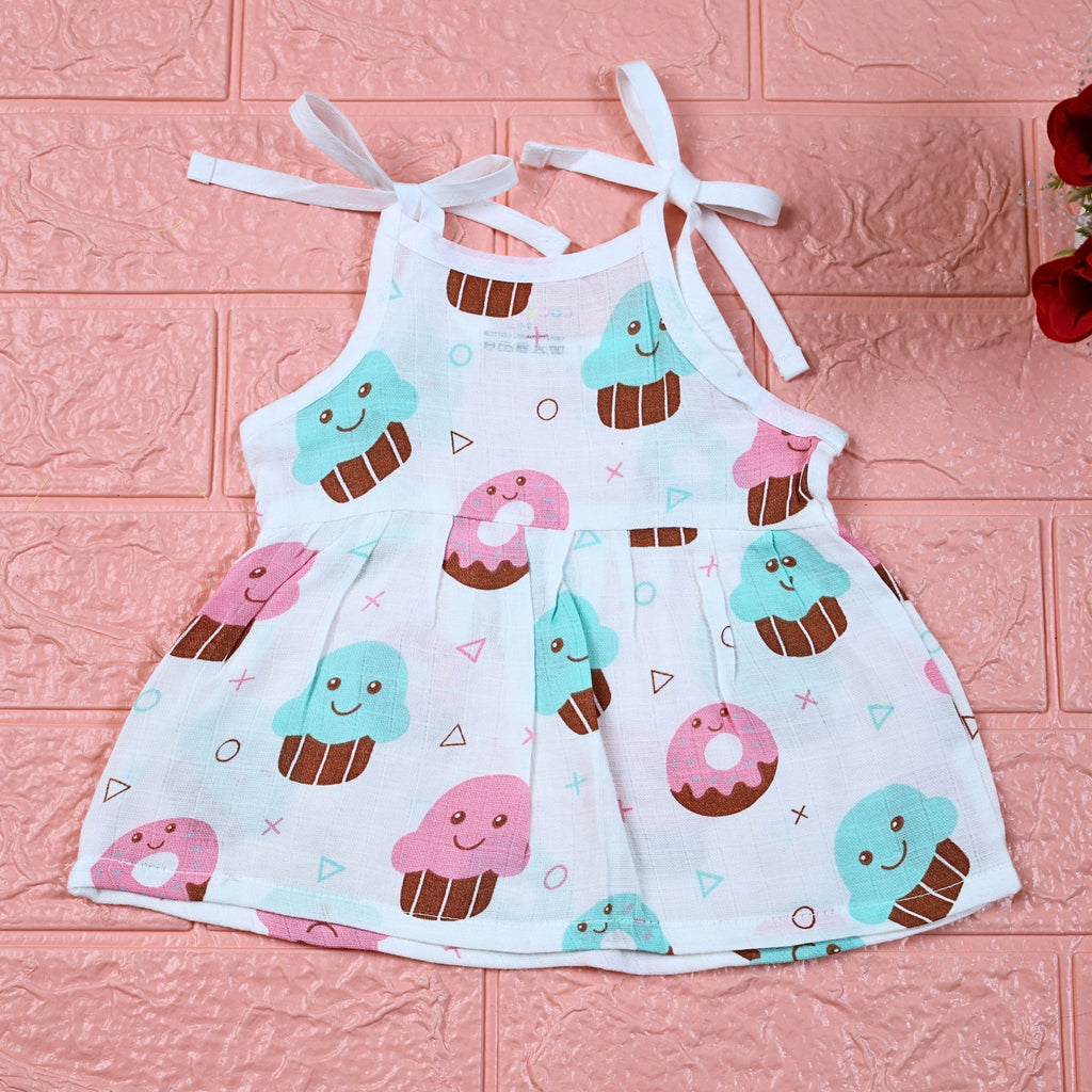 Sugar Rush baby frock in white printed with tie up shoulders, printed with cup cakes