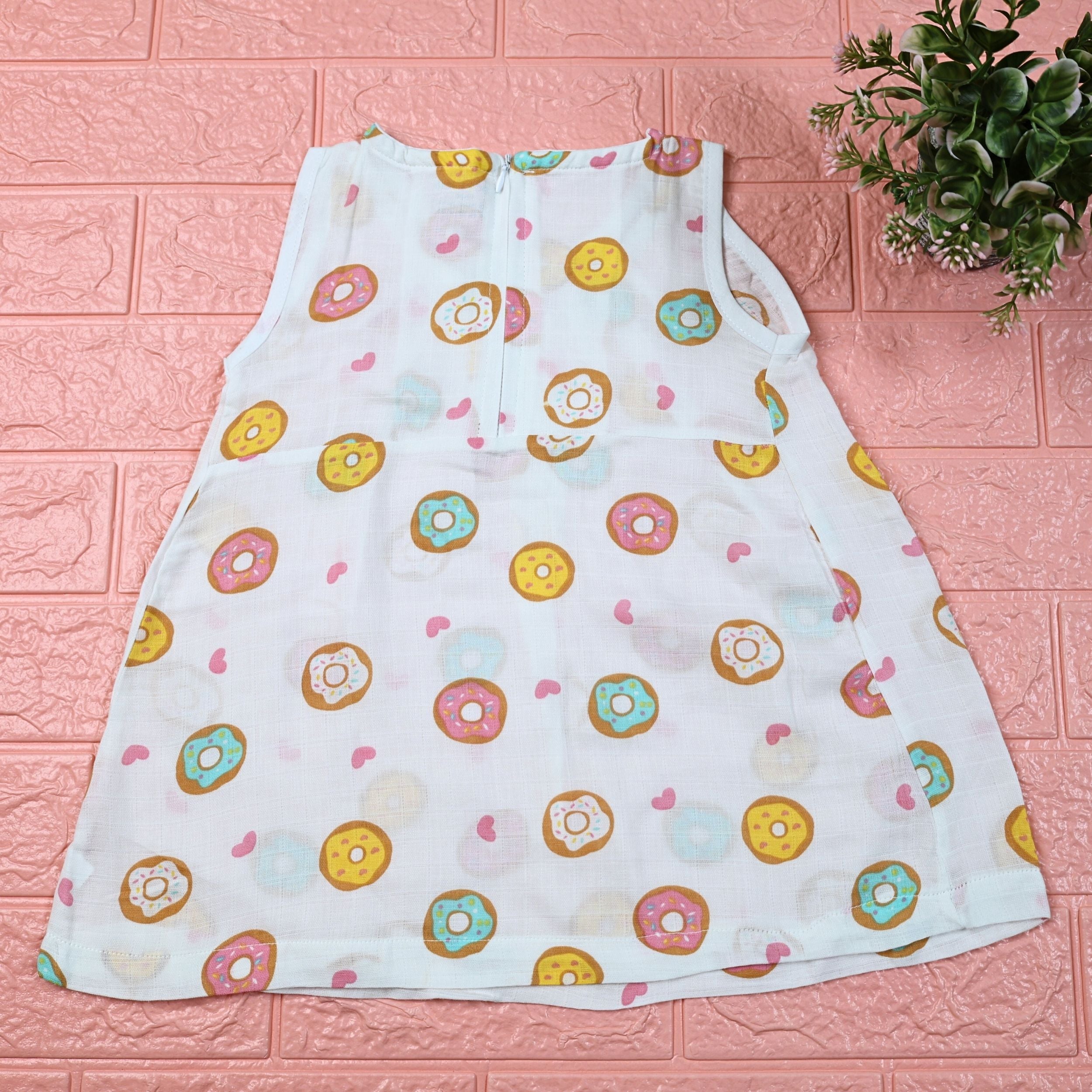 Donuts Baby sleeveless white frock with zip, printed with donut pattern