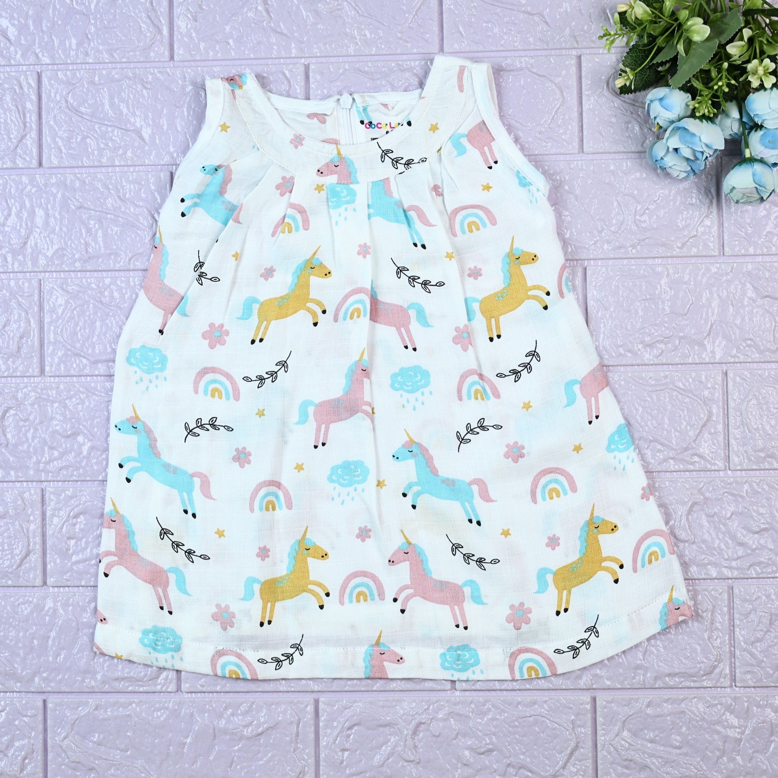 Unicorn baby sleeveless frock in white with zip, printed with unicorn and rainbow patterns