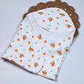 Citrus Bloom Baby hooded towel in white, printed with orange floral patterns