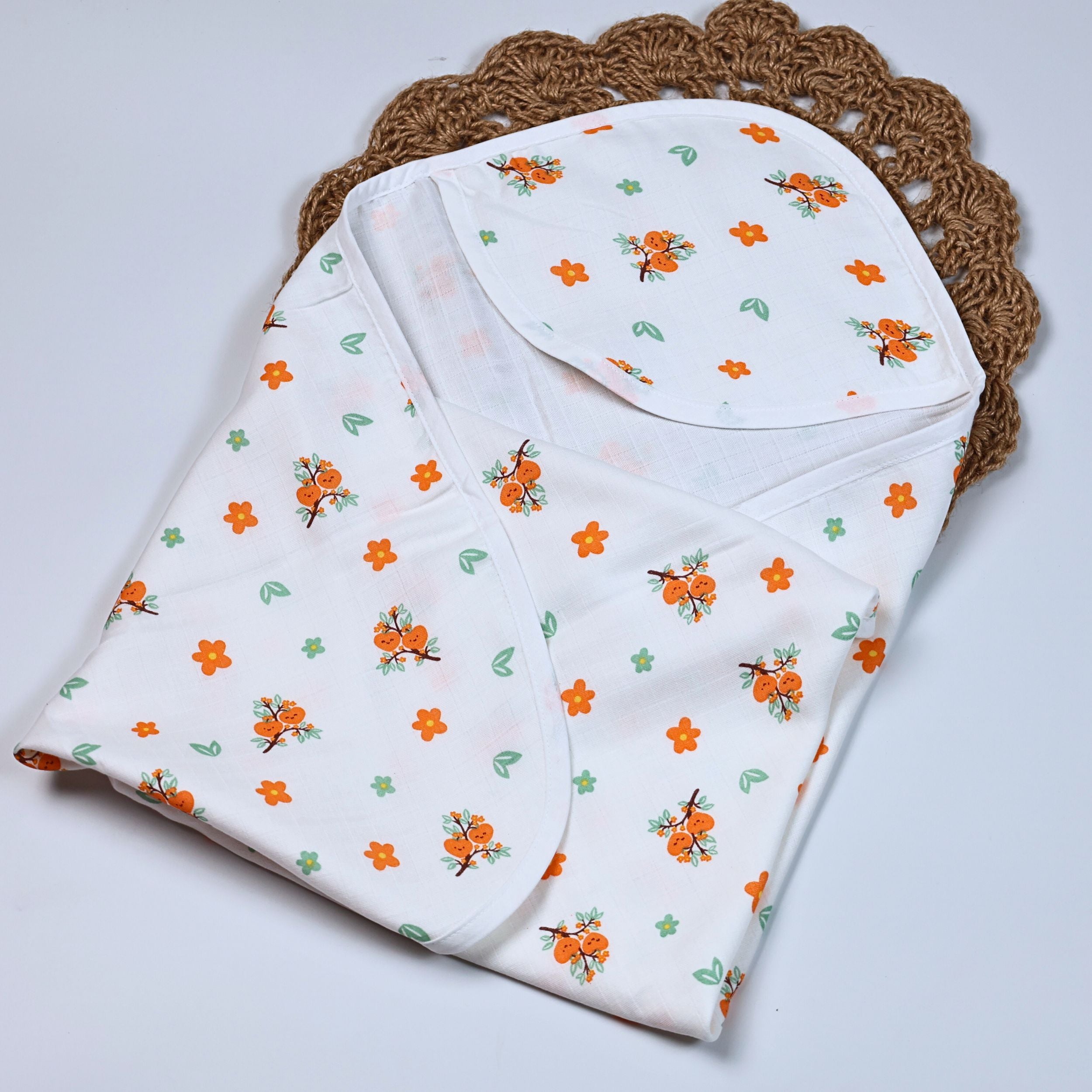 Citrus Bloom Baby hooded towel in white, printed with orange floral patterns