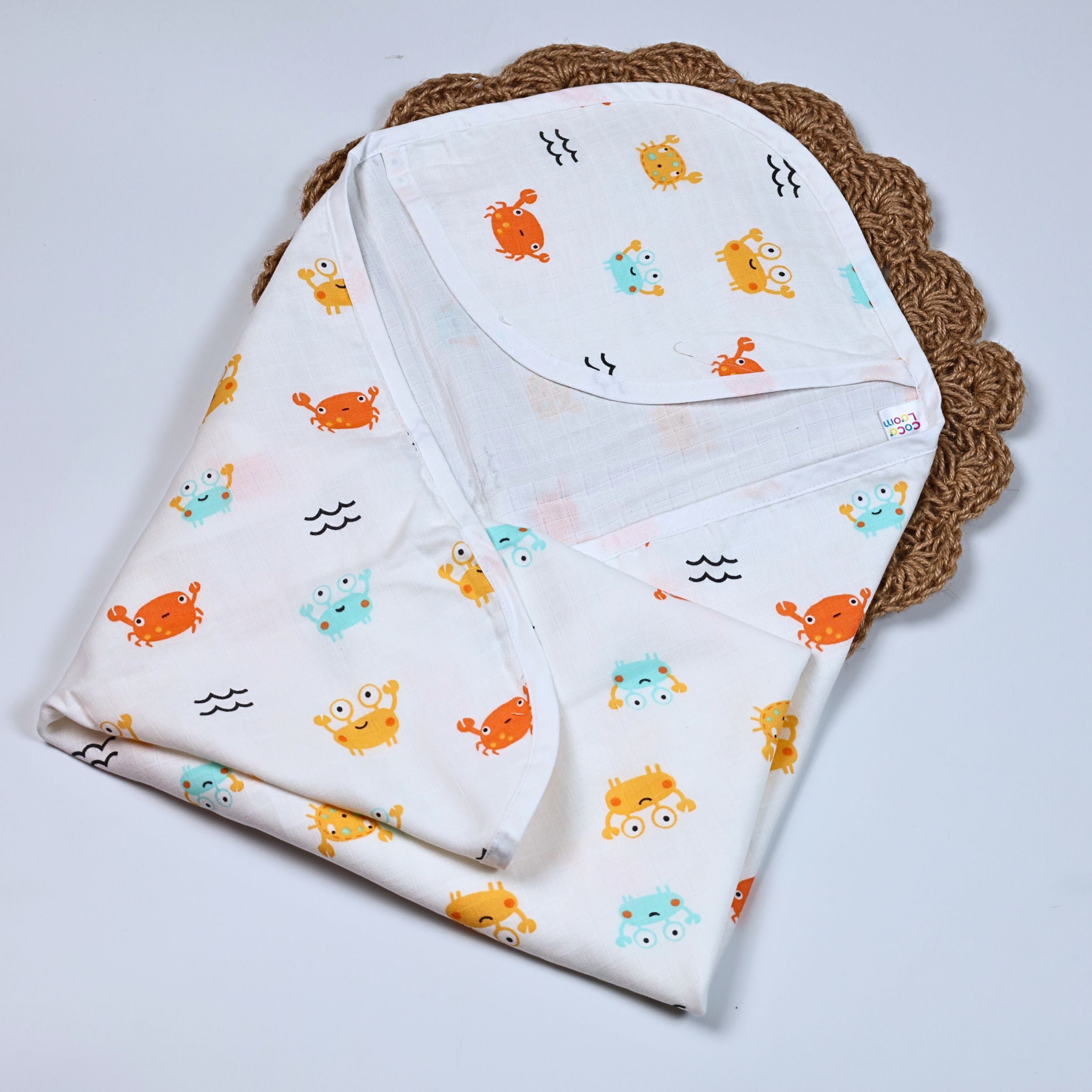 Happy Crabs baby hooded towel in white, printed with colourful crab pattern