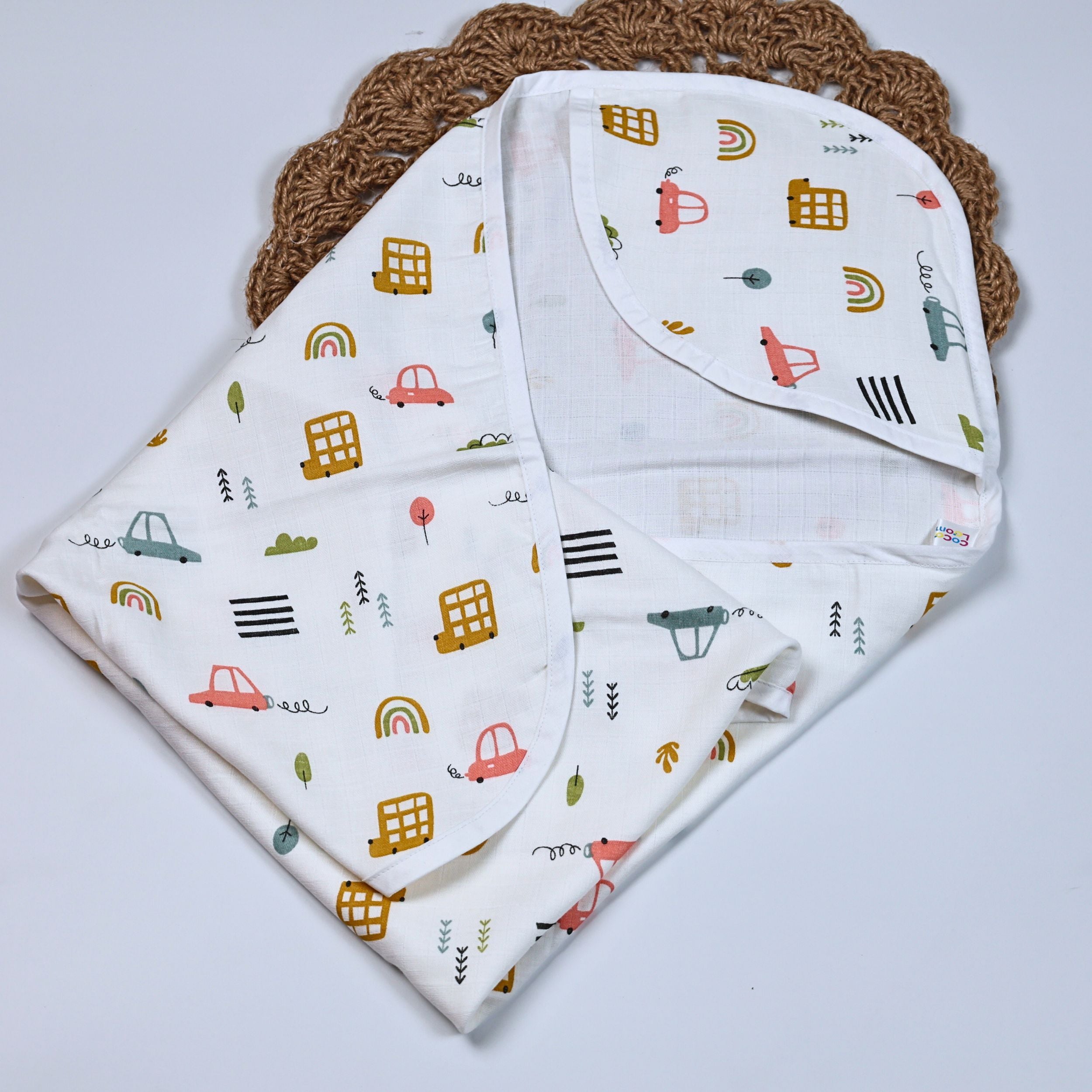 Little Wheels Baby hooded towel in white, printed with rainbow and playful vehicles themed pattern