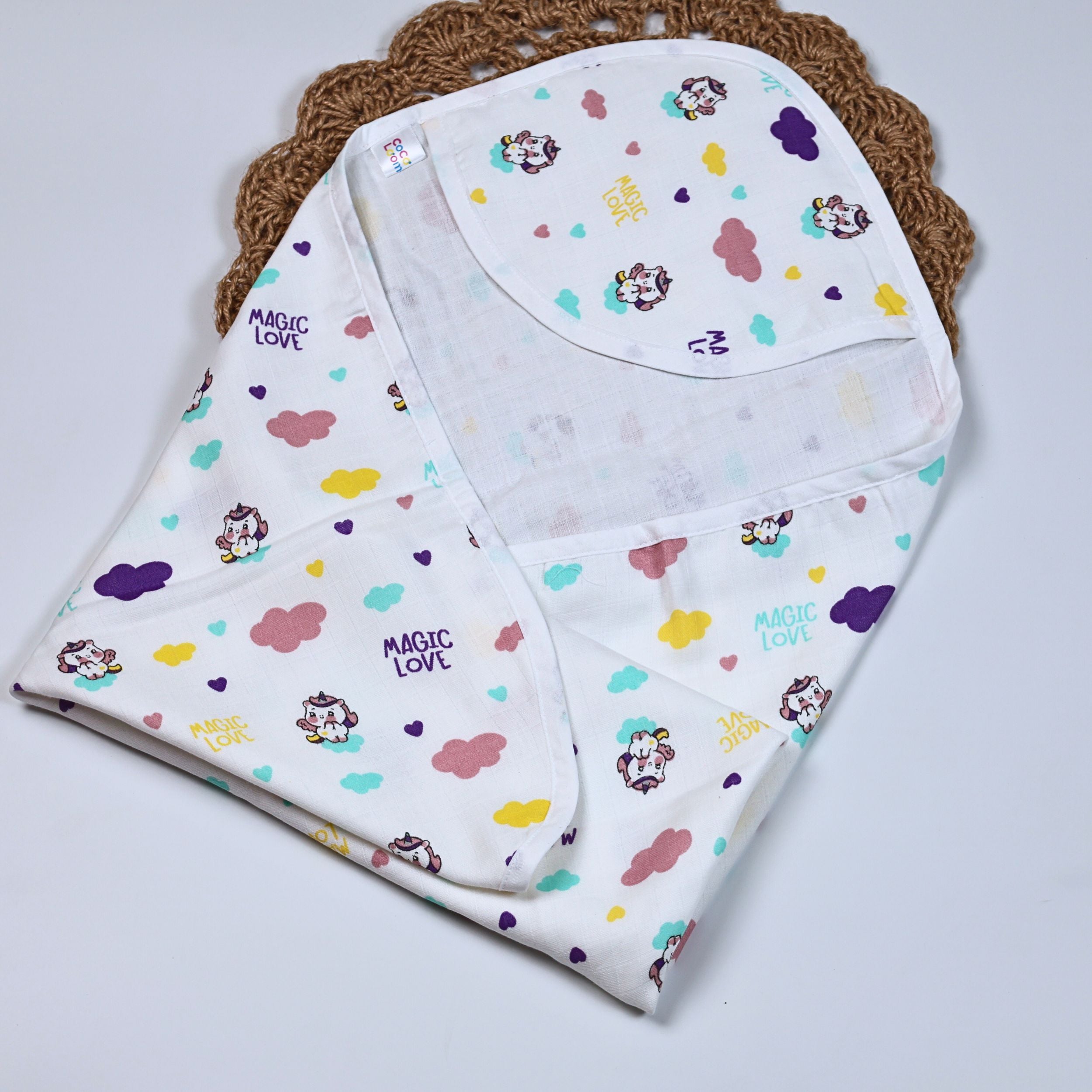 Purple Magic baby hooded towel in white, printed with colourful patterns