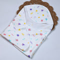 Shape Pops baby hooded towel in white printed with colorful geometric pattern