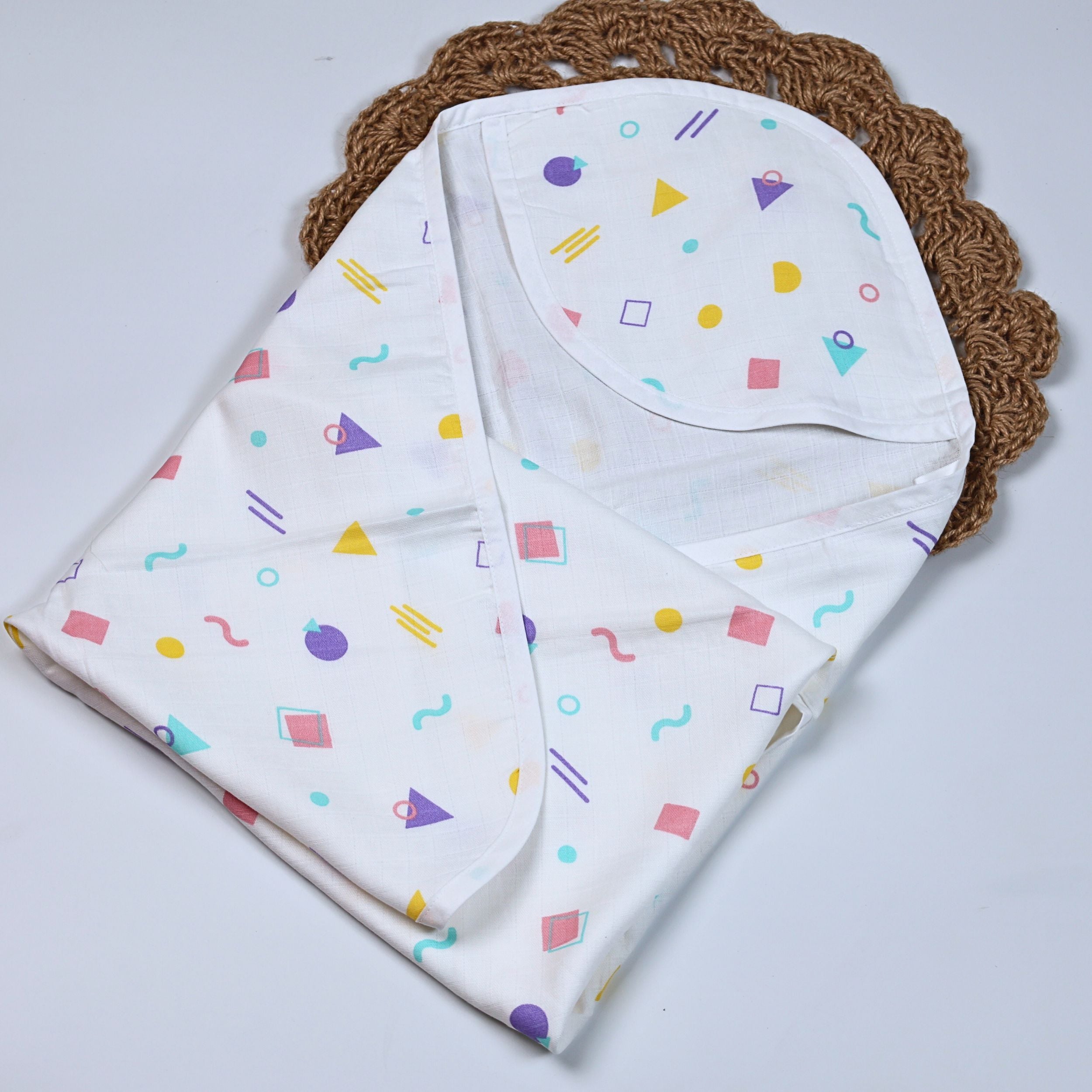 Shape Pops baby hooded towel in white printed with colorful geometric pattern