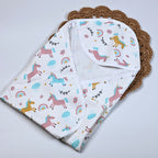 Unicorn baby hooded towel in white, printed with unicorn and rainbow patterns