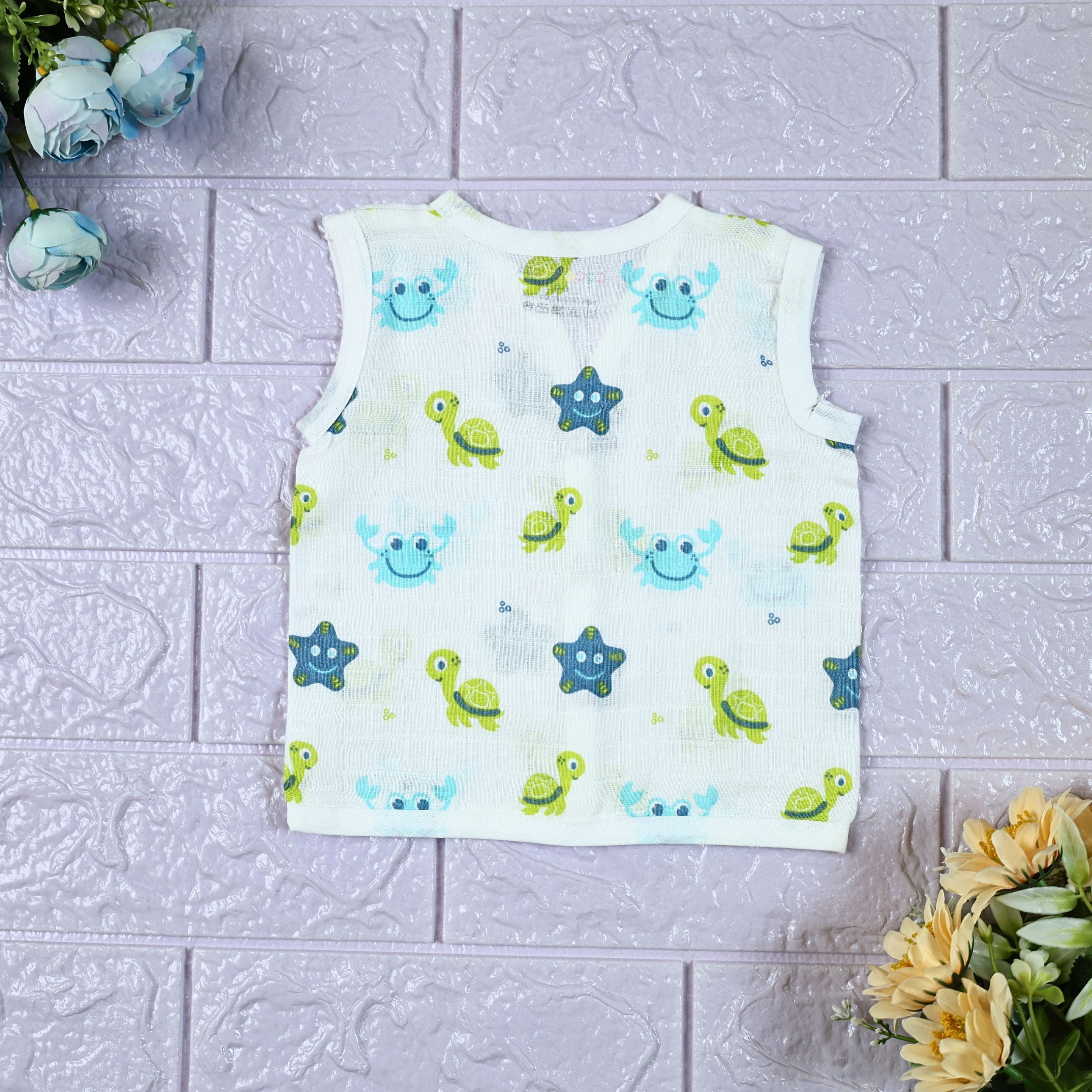 Aqua Babies baby sleeveless top in white with snap buttons printed with turtle and starfish pattern