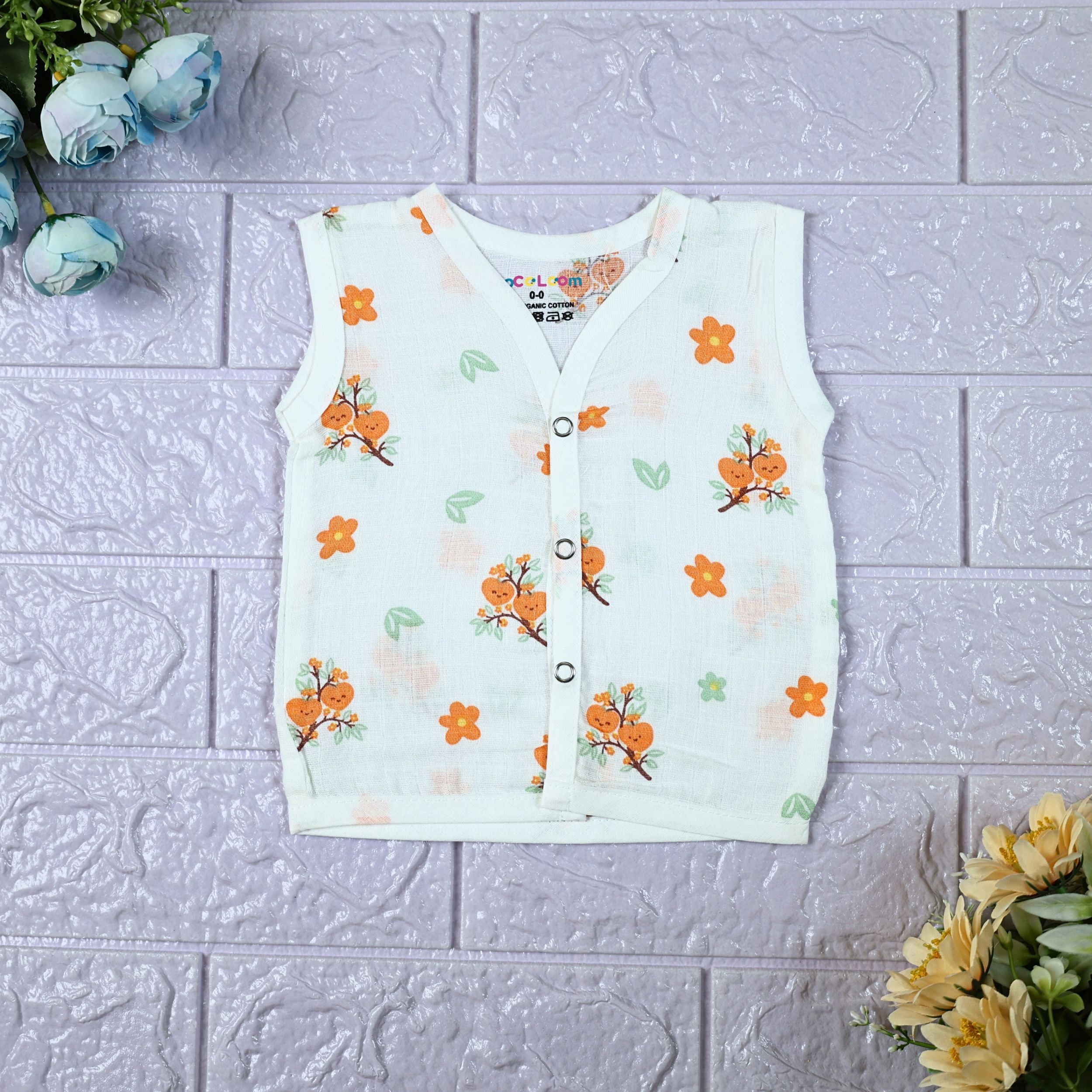 Citrus Bloom Baby sleeveless top in white with snap buttons, printed with orange floral patterns