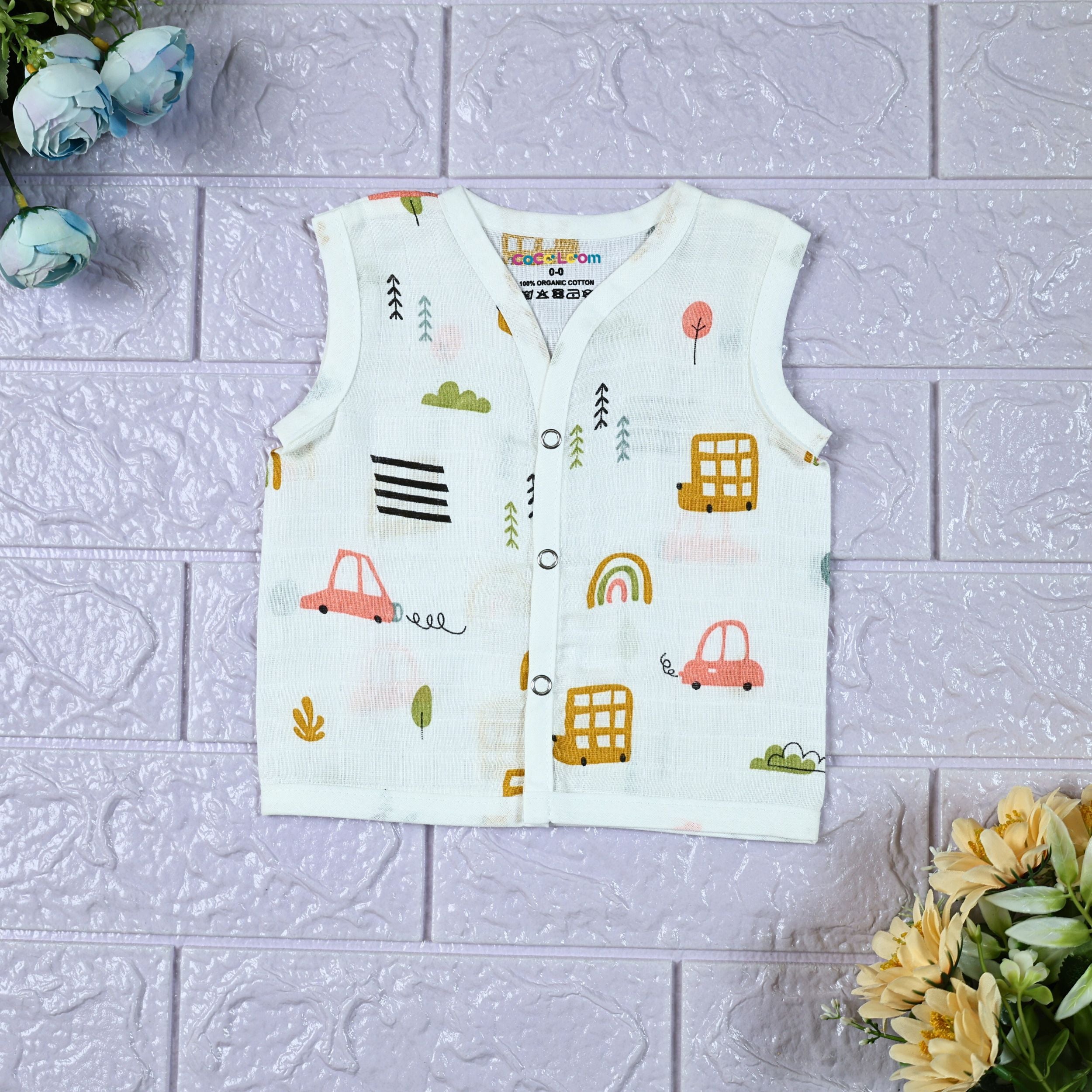 Little Wheels Baby sleeveless top in white with snap buttons, printed with rainbow and playful vehicles themed pattern