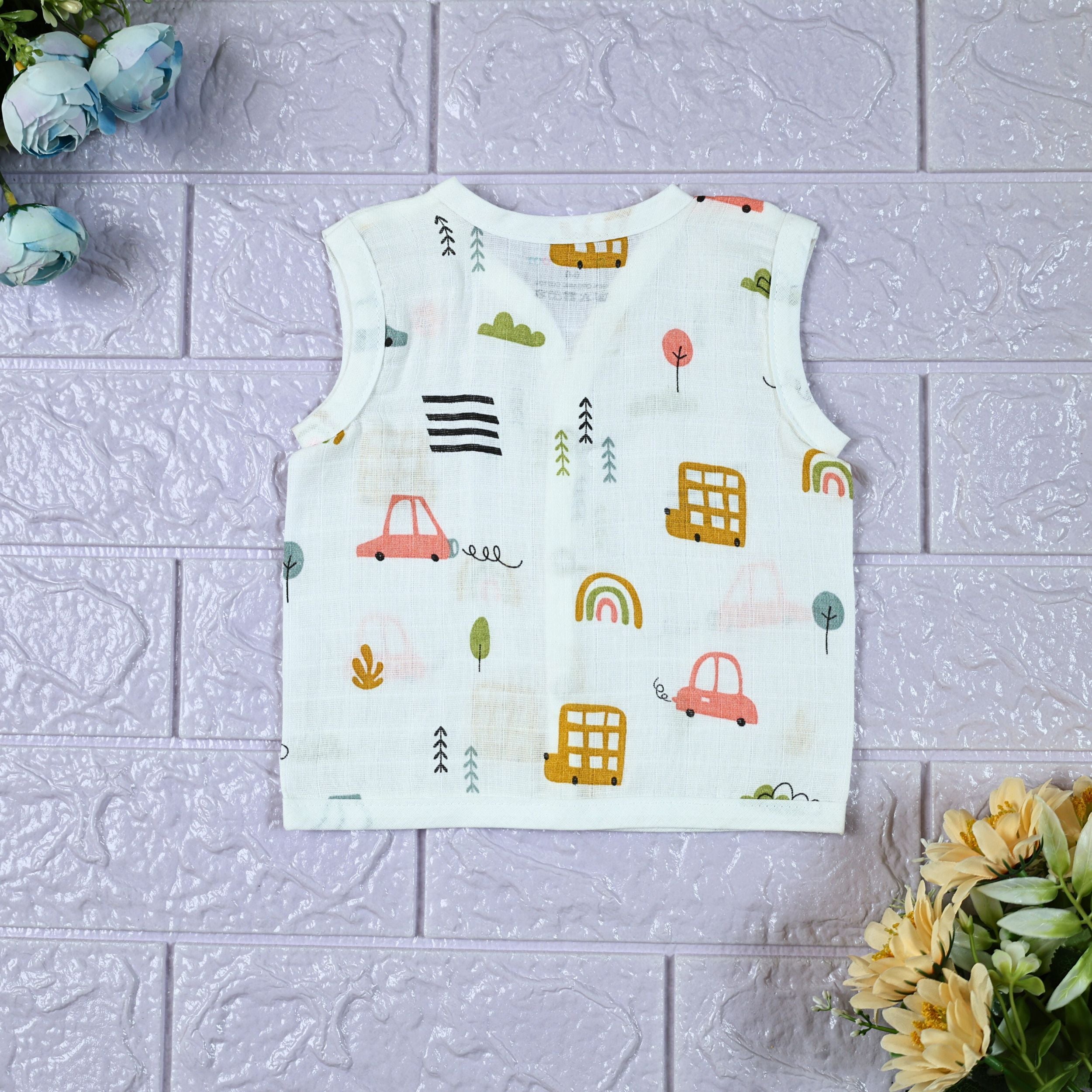 Little Wheels Baby sleeveless top in white with snap buttons, printed with rainbow and playful vehicles themed pattern