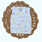 Shape Pops baby sleeveless top in white with snap buttons printed with colorful geometric pattern
