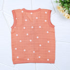 Daisy Daze baby sleeveless top in orange color with snap buttons printed with white floral patterns