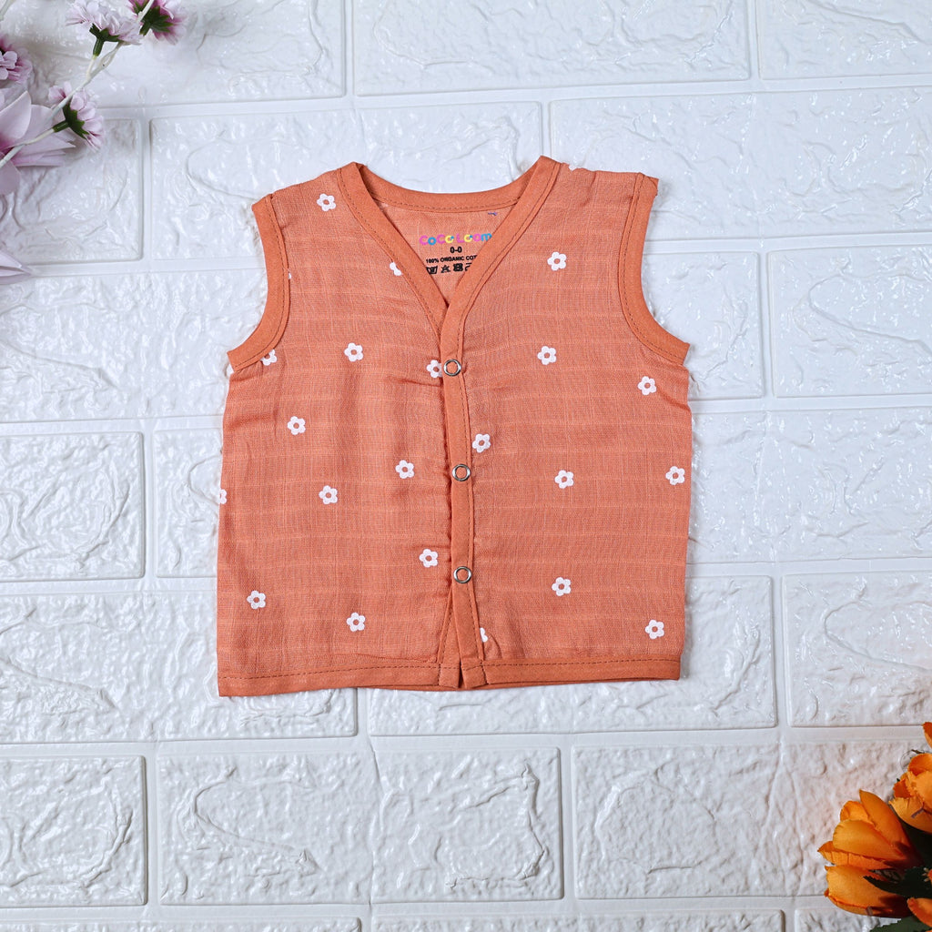 Daisy Daze baby sleeveless top in orange color with snap buttons printed with white floral patterns