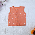 Daisy Daze baby sleeveless top in orange color with snap buttons printed with white floral patterns