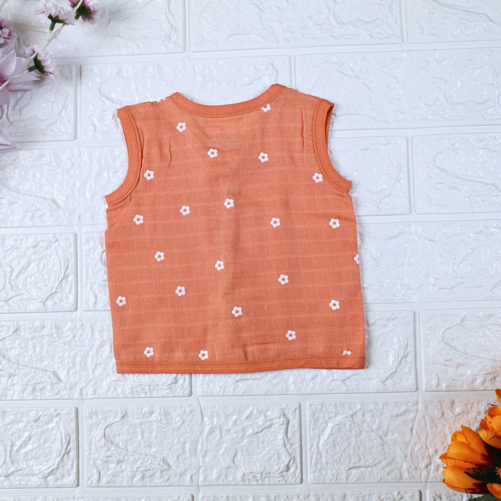 Daisy Daze baby sleeveless top in orange color with snap buttons printed with white floral patterns